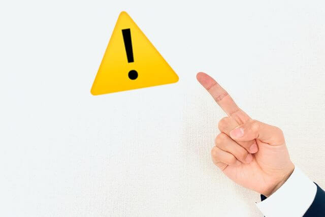 A warning triangle and a pointing-finger gesture