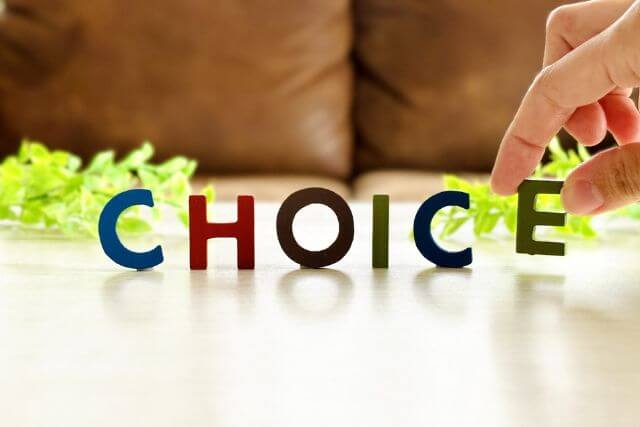 Colorful letter tiles spelling out a choice